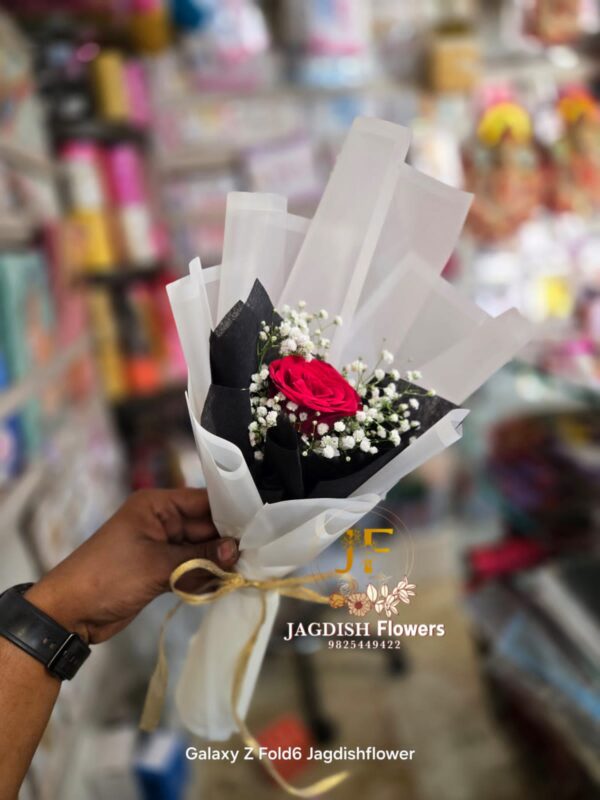 Red rose with gypso in white paper bouquet